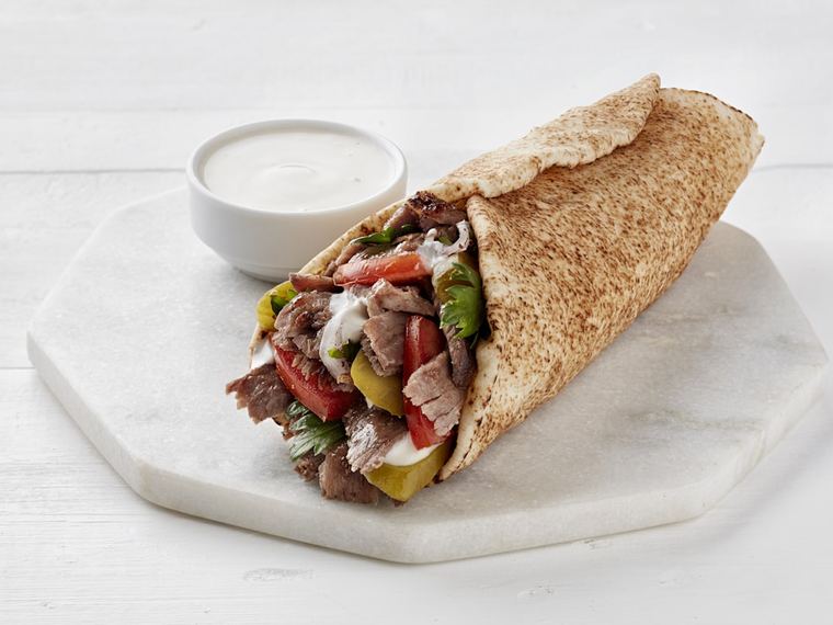 Shawarma wrapped in flatbread, served with garlic sauce